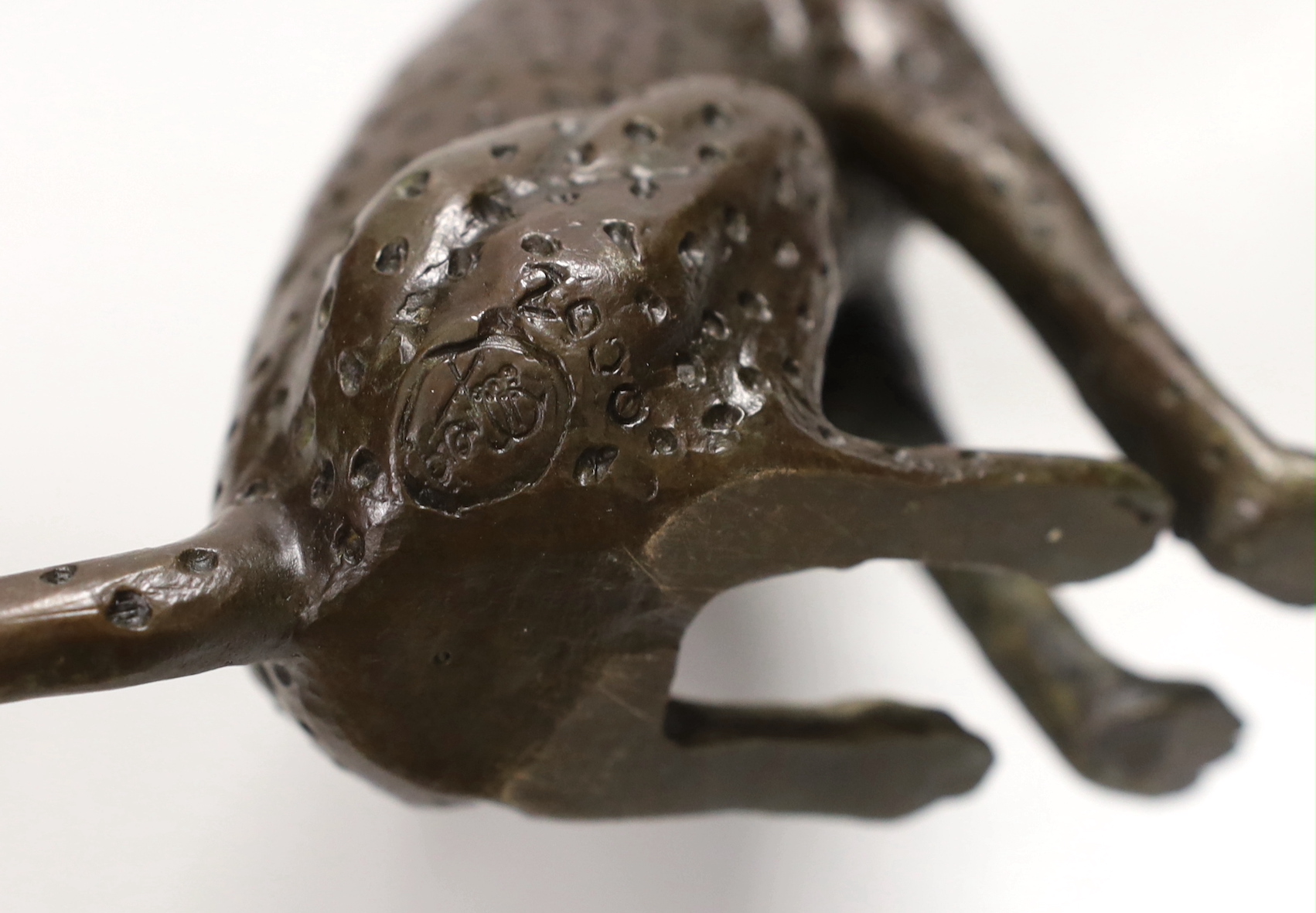 A small contemporary bronze seated leopard, stamped and dated 2000 to underside, 15cm high